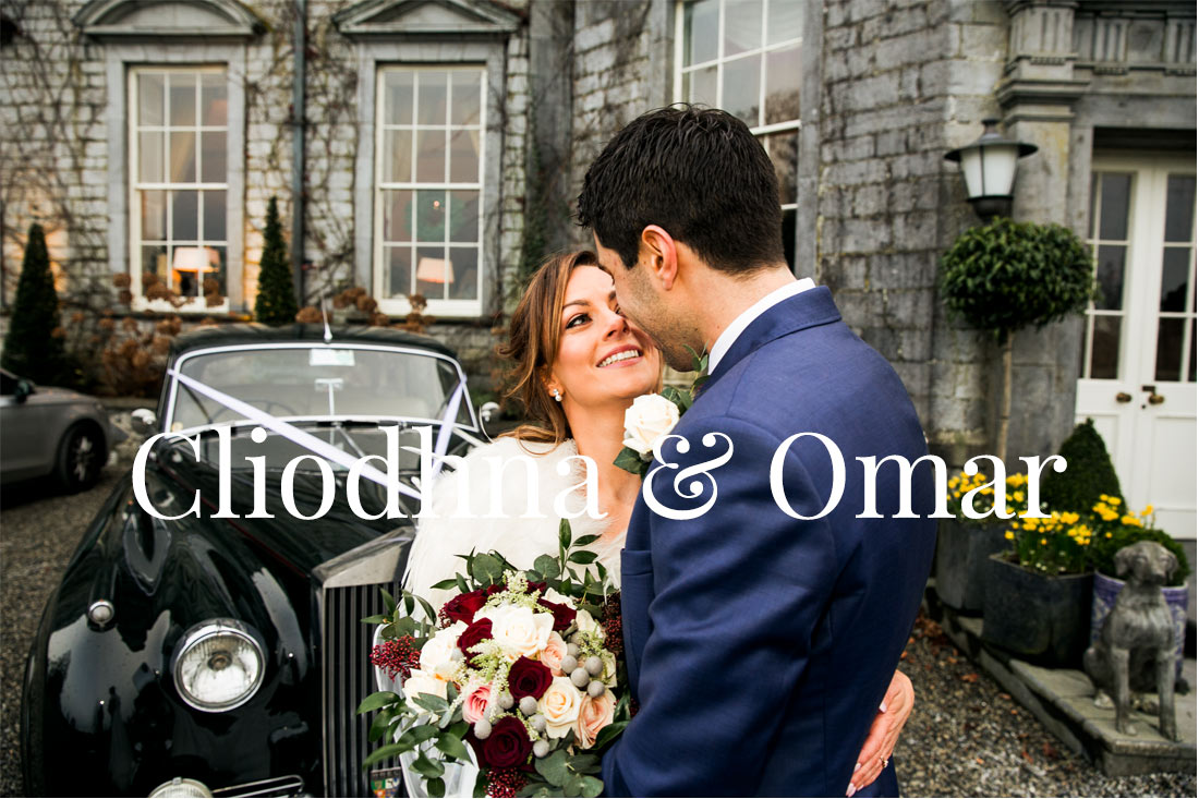 bride and groom pose with the car outside castle durrow
