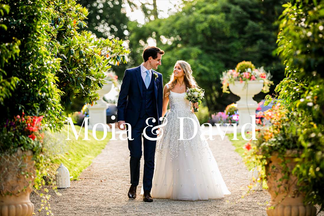 Moia & David walk hand in hand in the grounds of Tinakilly House