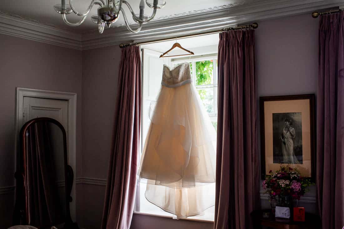wedding dress hanging in window at cloughjordan house