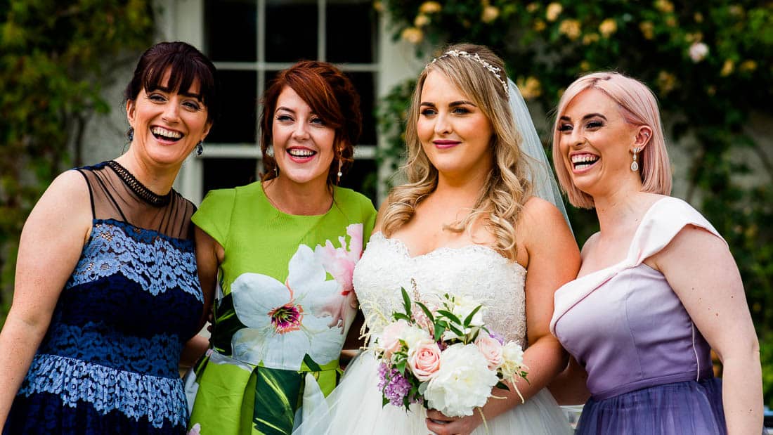the bride and her friends having their photo taken in cloughjordan house gardens
