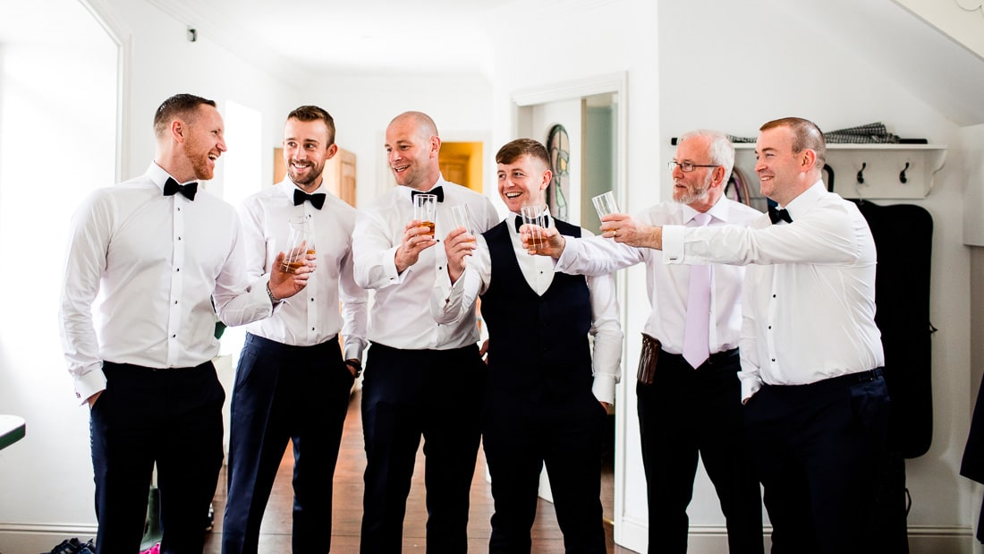groom and groomsmen having a drink