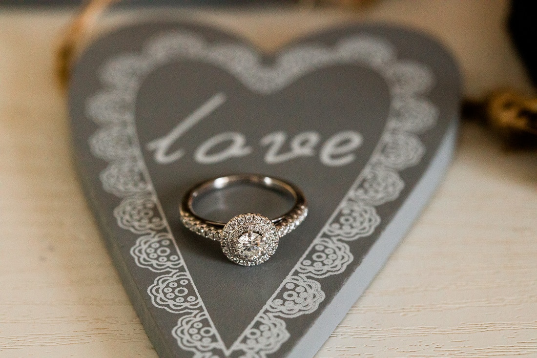 engagement ring sitting on a sign that says love