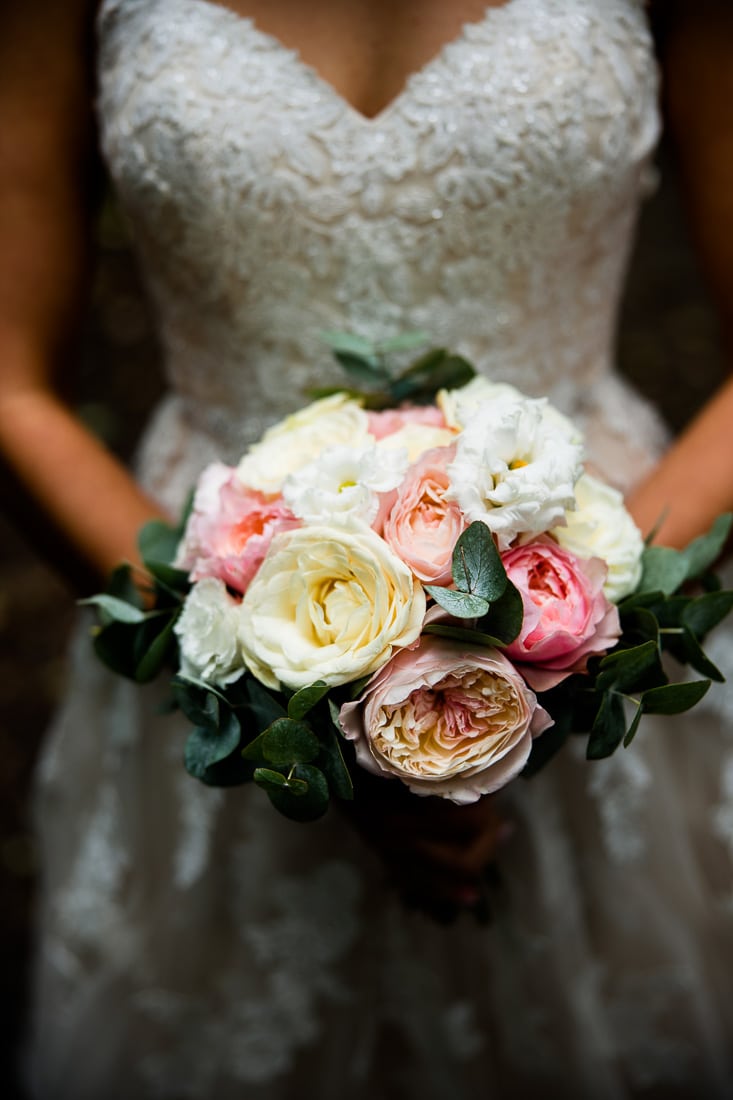 a bride holds her bouquet to the camera