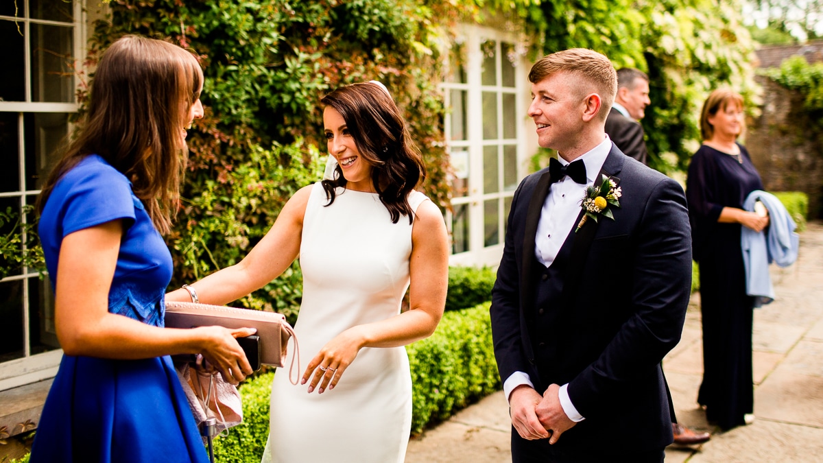 the bride and groom welcome their guest to a wedding Wedding At Ballintubbert Gardens and House