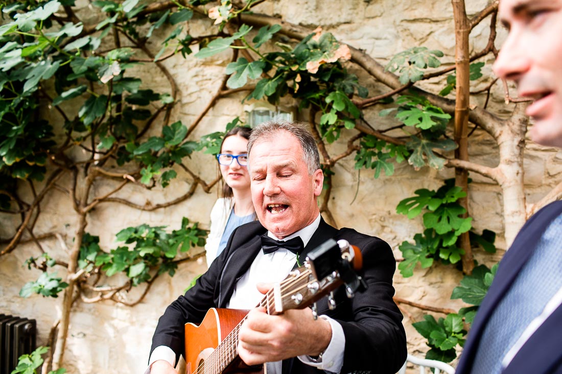 man plays a guitar at the cliff at lyons wedding
