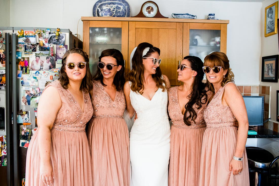 bride and her bridesmaids wearing sunglasses