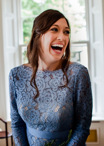 bridesmaid laughs at the wedding photographer