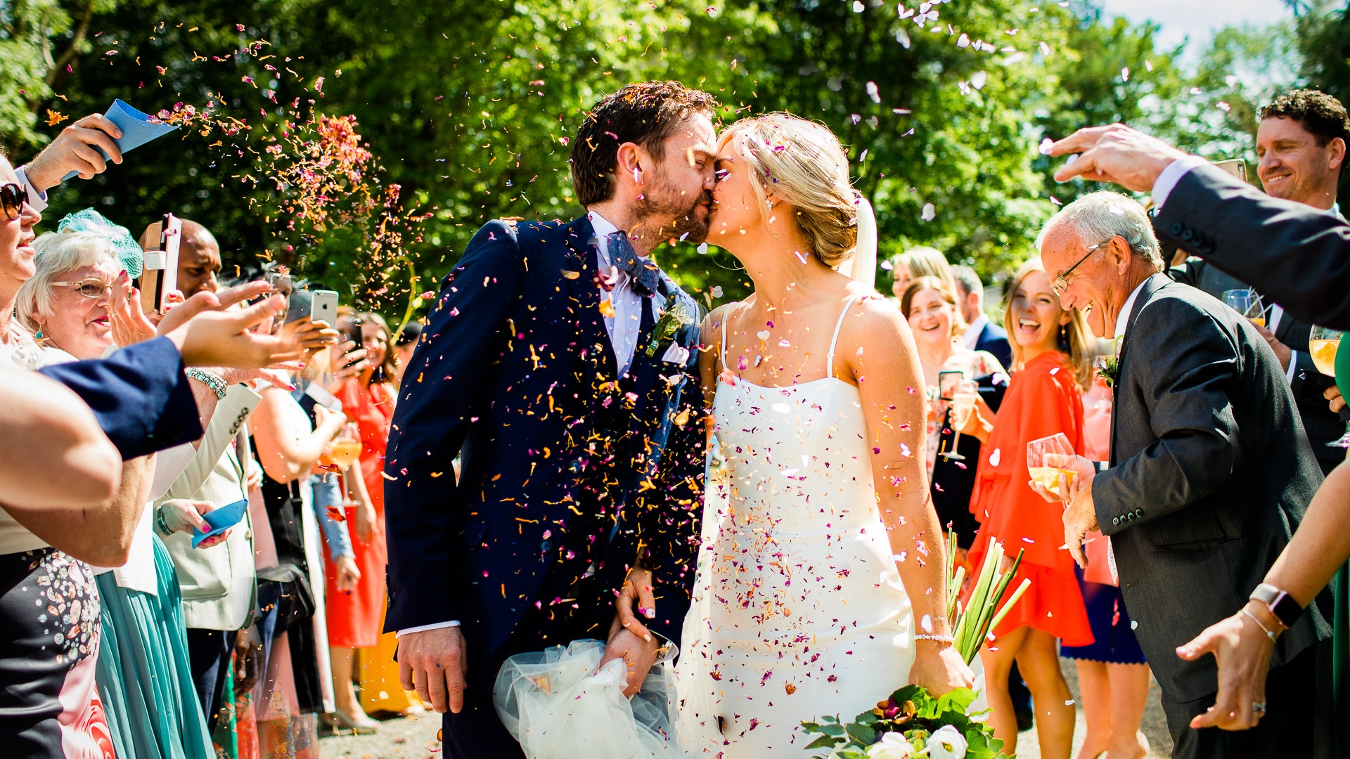 bride and groom under some confetti