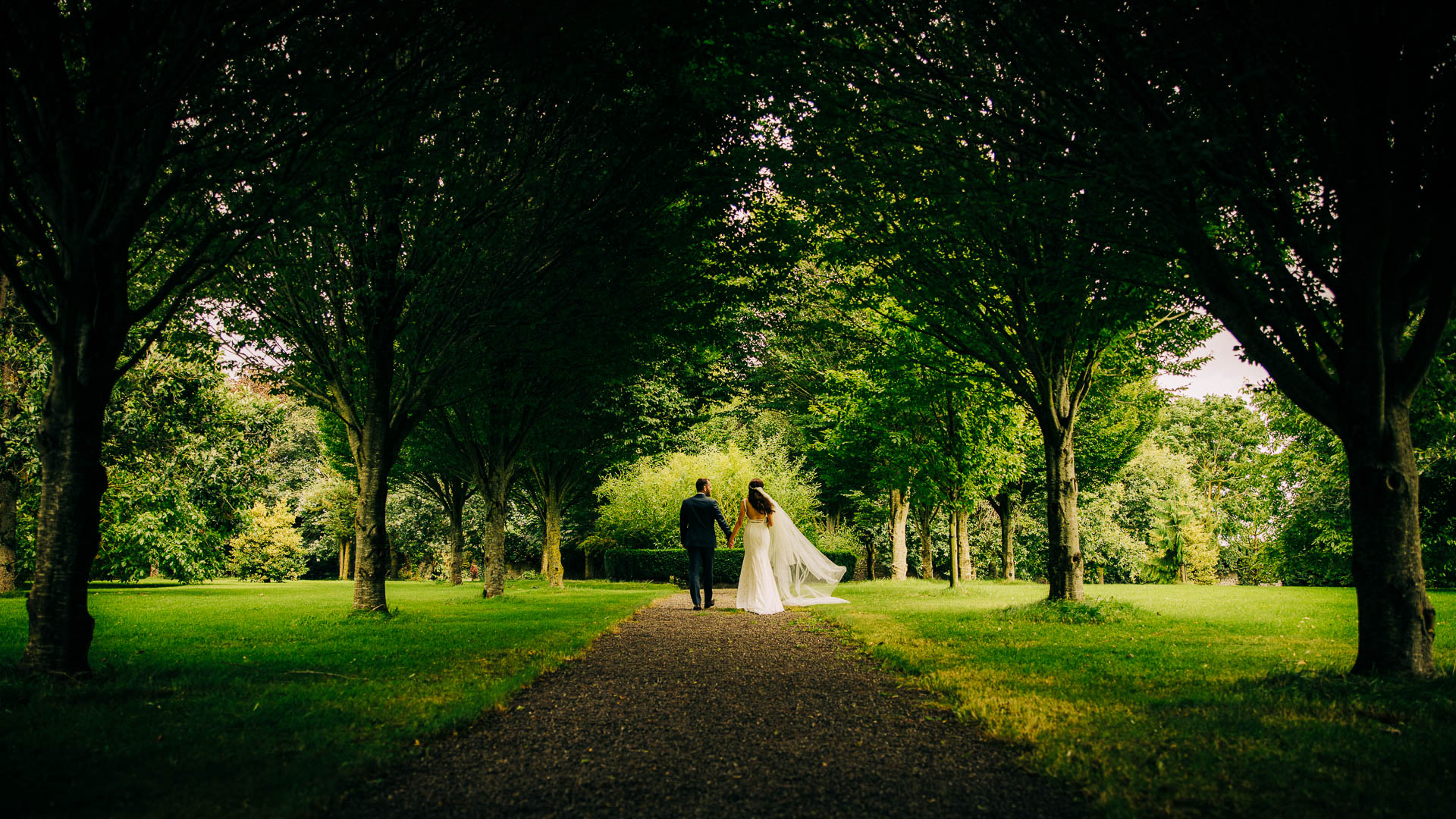 bride and groom walking in barberstown gardens