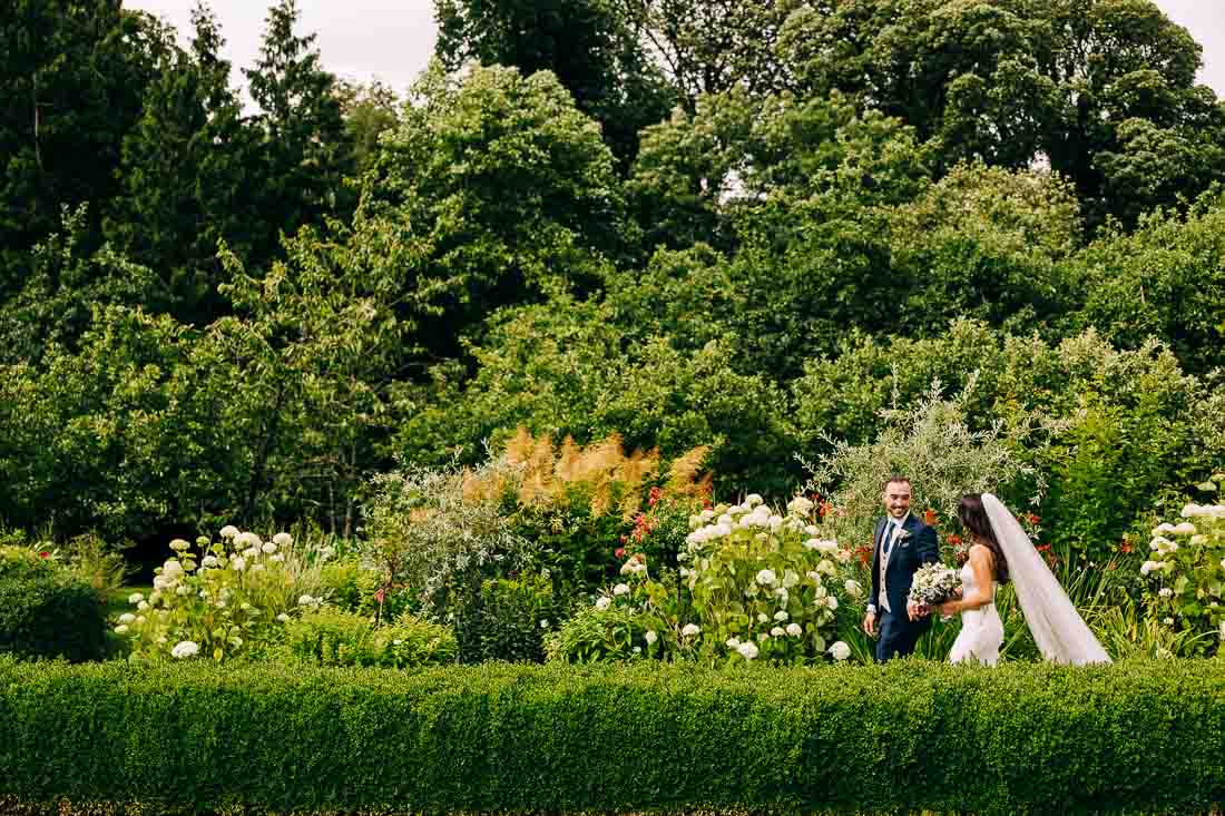 bride and groom walking in rathsallagh house walled garden