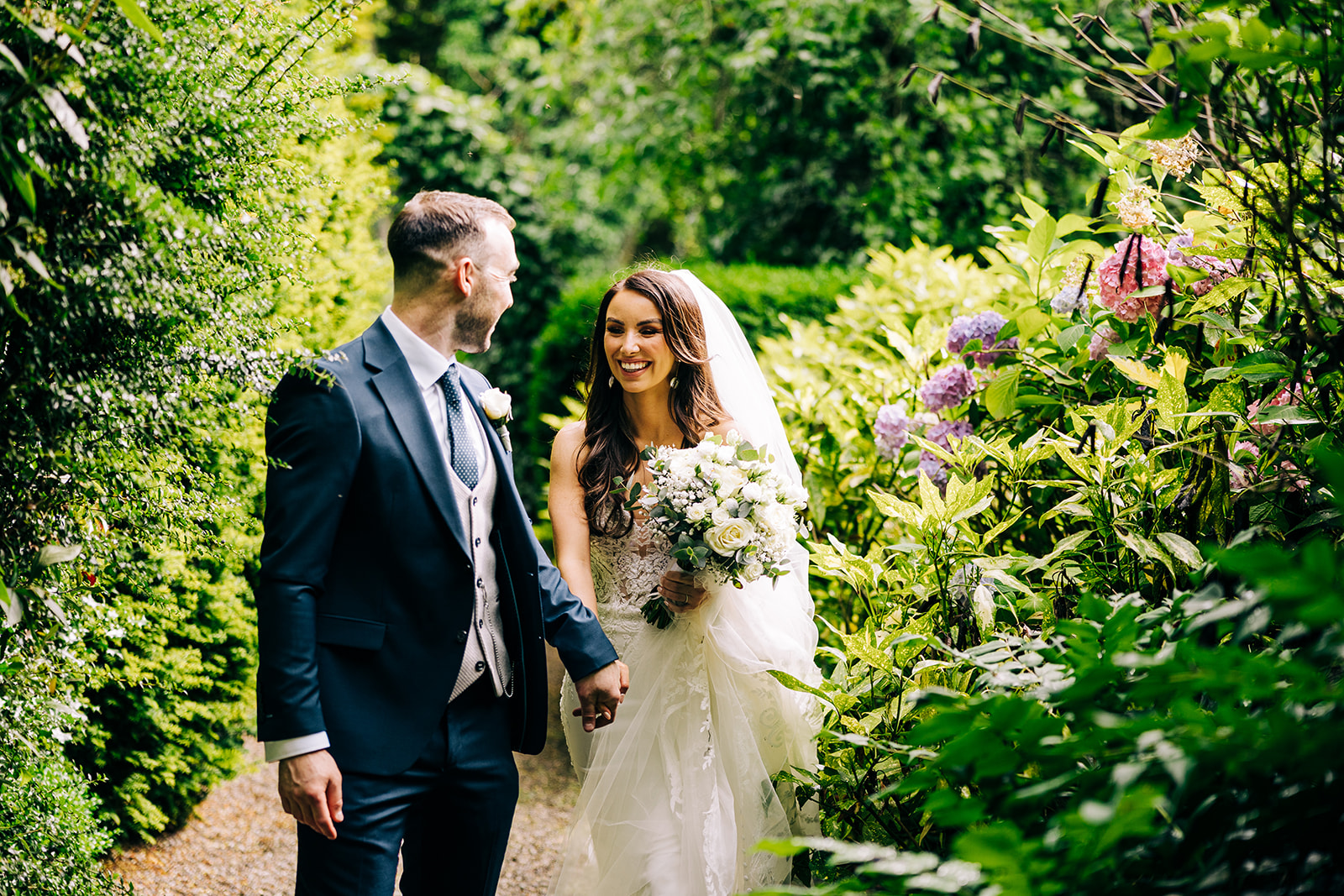 Gráinne & Killian | Rathsallagh House bride and groome walk togeather in the walled garden in Rathsallagh House