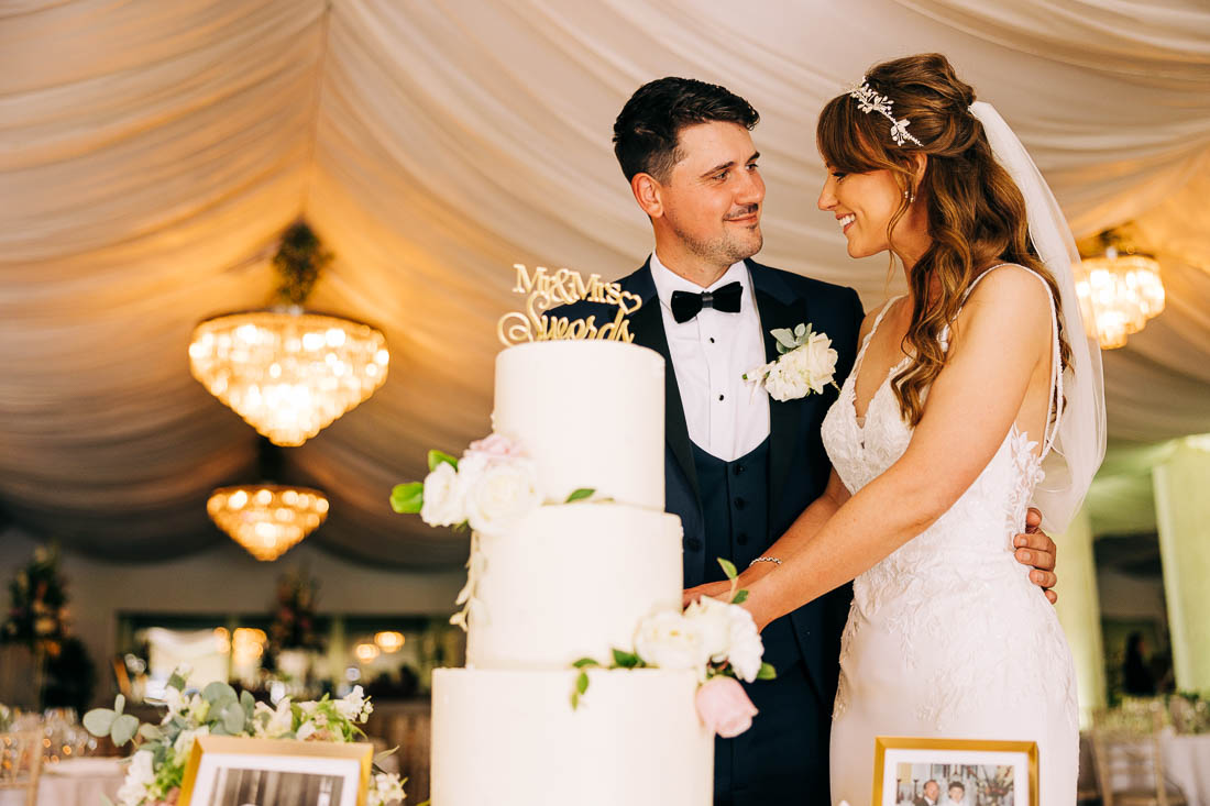 Couple cutting their wedding cake at Rathsallagh House