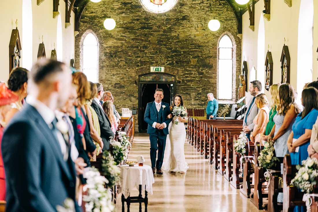 Dad walking his daughter down the isle at Saint Nicholas Of Myra RC Church,