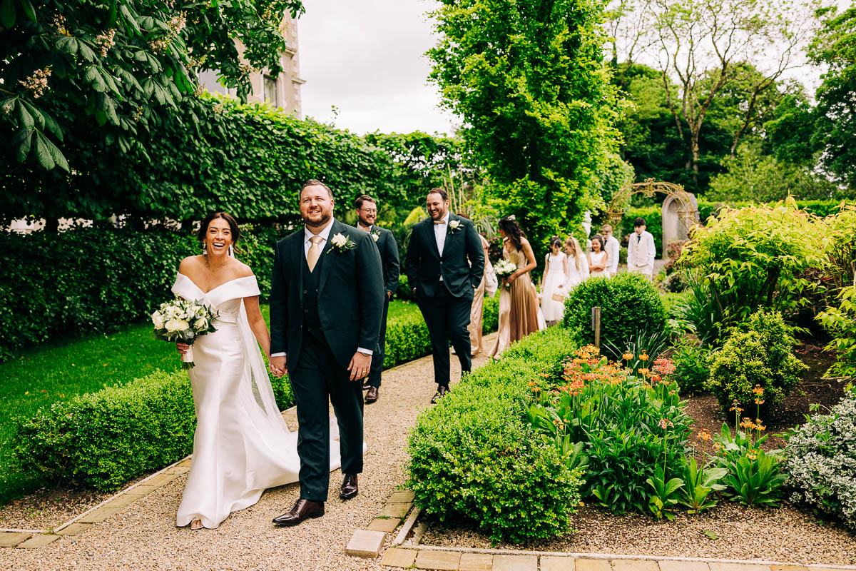 I newly married Couple walk in Emma's butterfly garden at the killashee hotel