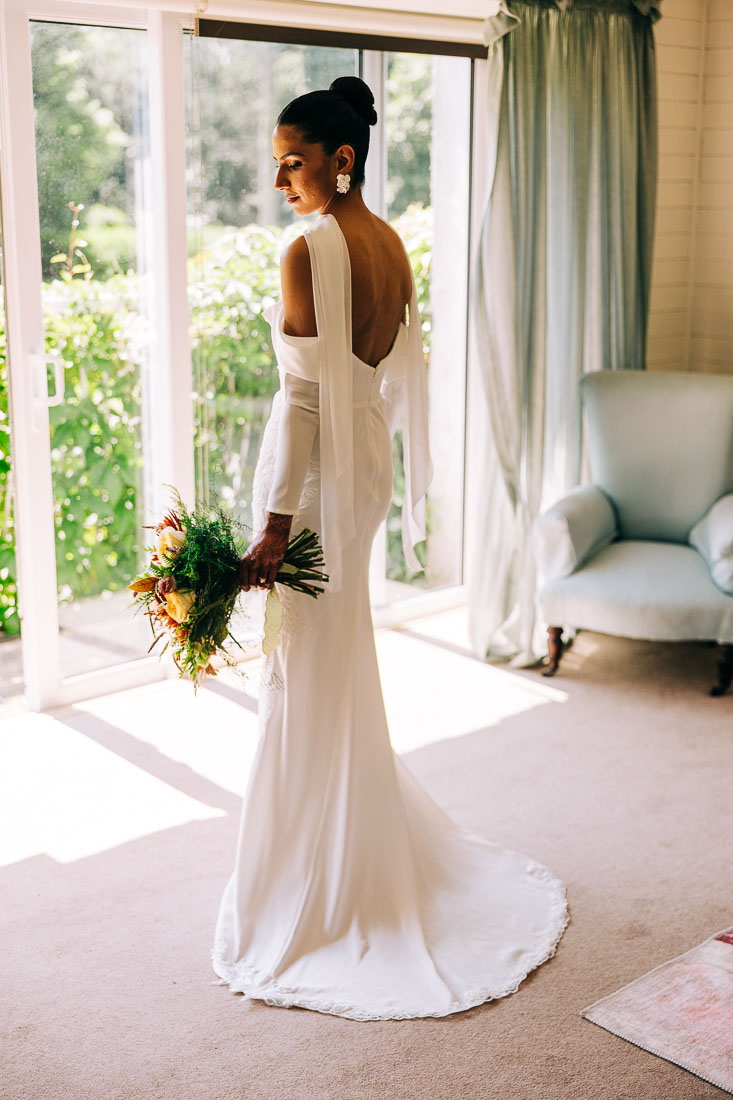 rathsallagh-house-wedding-jess-1 bride in open back wedding dress holding bouquet at Rathsallagh House Co. Wicklow