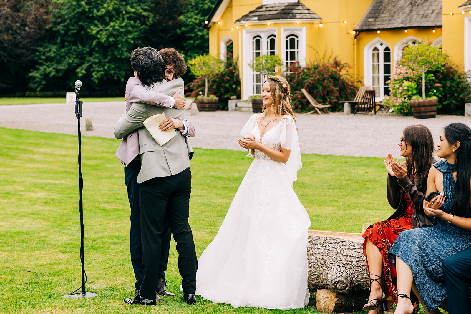 Magdalena & Ronan | Martinstown House groom hugging the best man after an emotional speech at Martinstown House bride looking on smiling